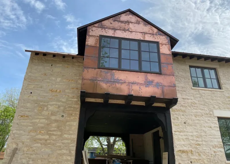 Copper metal panel facade on a stone building for Roof Repair in Uniontown